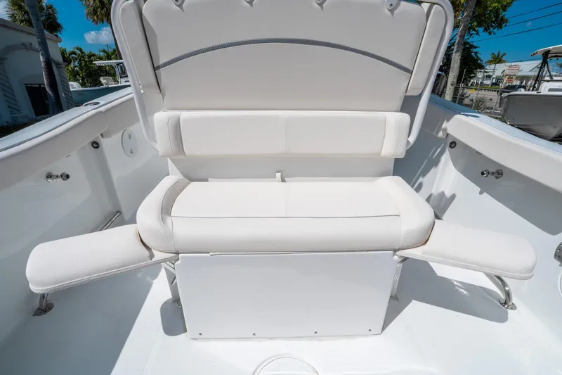 Slide: The Image of 2025 Sea Hunt Ultra 255 SE boat with white cushioned seating. - 16
