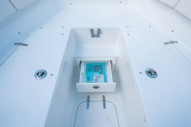 Slide: The Image of 2025 Sea Hunt Ultra 255 SE boat storage compartment with open drawer. - 30