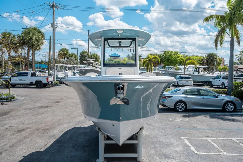 Slide: The Image of 2025 Sea Hunt Ultra 255 SE boat displayed outdoors on a sunny day. - 7