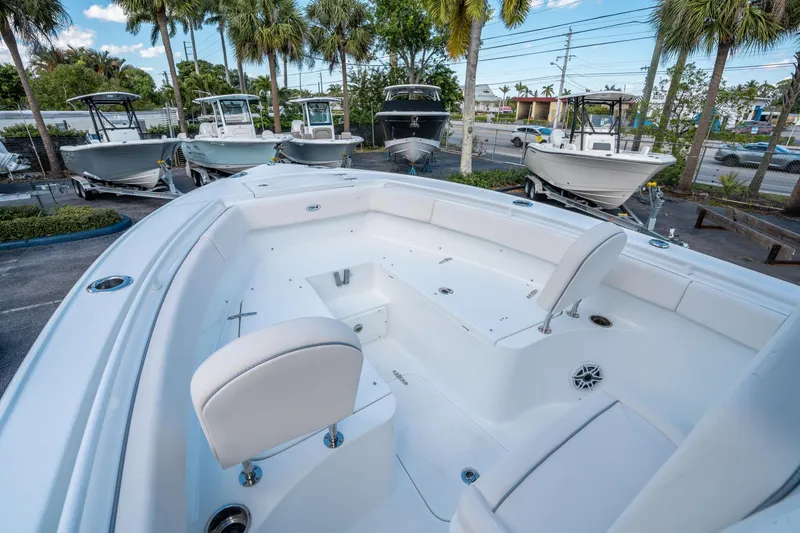 Slide: The Image of 2025 Sea Hunt Ultra 255 SE boat interior with seating, parked among other boats. - 28