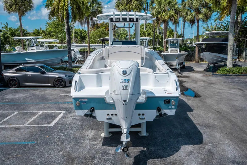 Slide: The Image of 2025 Sea Hunt Ultra 255 SE boat with Yamaha 300 V6 engine, parked outdoors. - 3