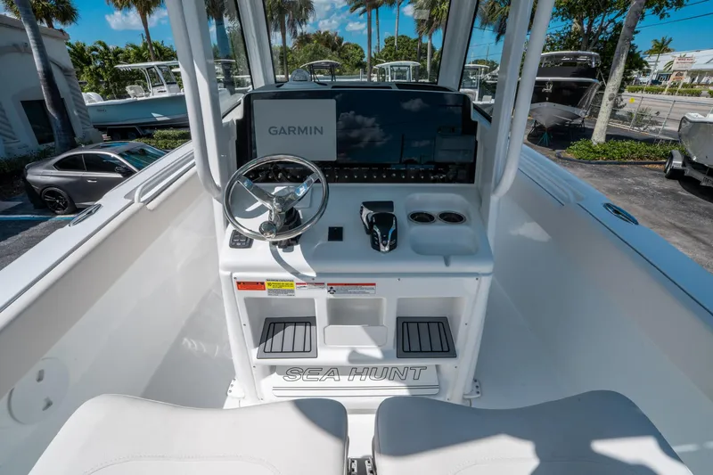 Slide: The Image of 2025 Sea Hunt Ultra 255 SE boat dashboard with Garmin navigation system and steering wheel. - 18