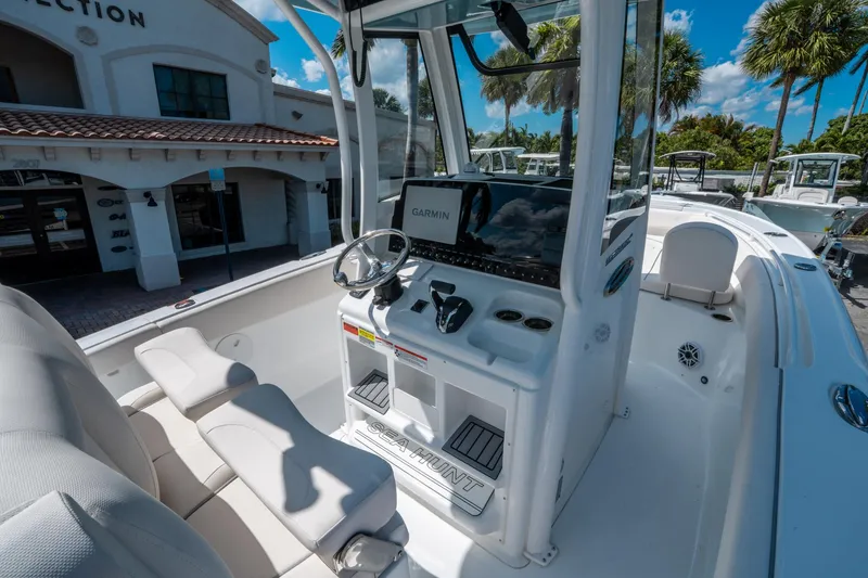 Slide: The Image of 2025 Sea Hunt Ultra 255 SE boat interior with steering console and seating. - 20