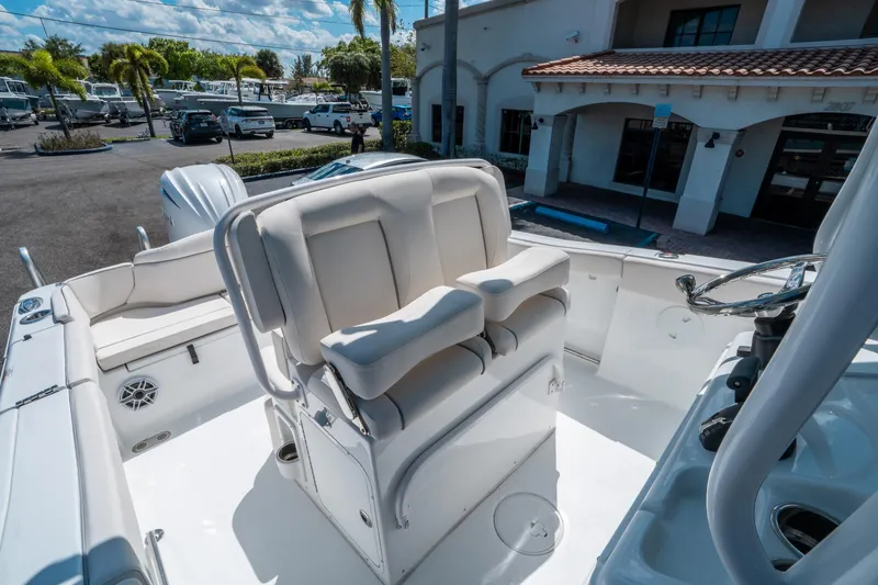 Slide: The Image of 2025 Sea Hunt Ultra 255 SE boat interior with plush seating and modern steering console. - 22