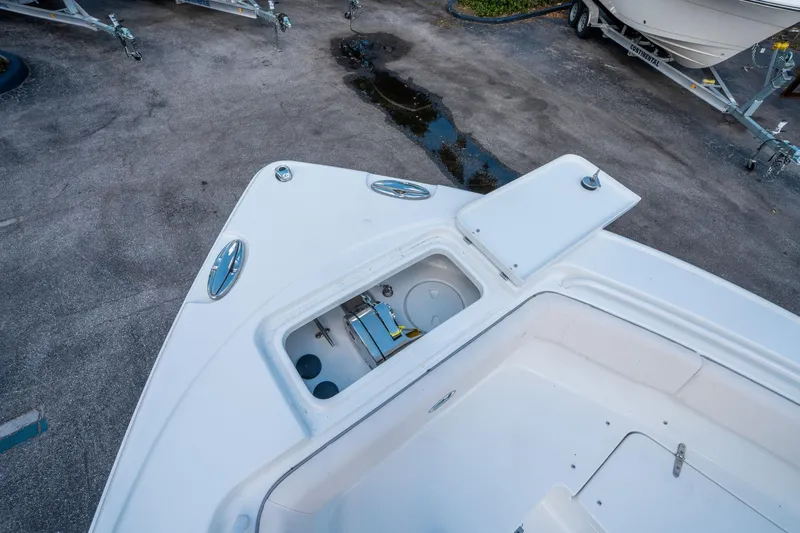 Slide: The Image of 2025 Sea Hunt Ultra 255 SE boat deck with open storage compartment. - 31
