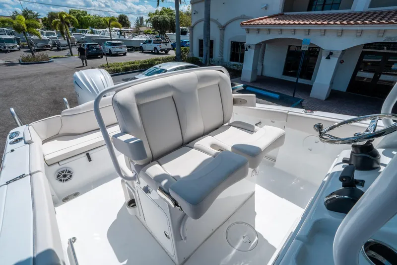 Slide: The Image of 2025 Sea Hunt Ultra 255 SE boat interior with plush seating and steering wheel. - 23