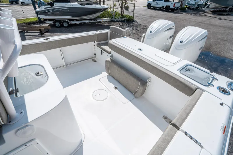 Slide: The Image of 2025 Sea Hunt Gamefish 27 FS boat interior with dual engines and seating area. - 11