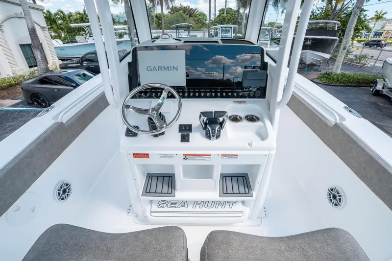 Slide: The Image of 2025 Sea Hunt Gamefish 27 FS boat console with Garmin display and steering wheel. - 17