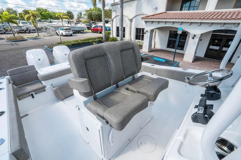 Slide: The Image of 2025 Sea Hunt Gamefish 27 FS boat interior with gray seating and steering wheel. - 22