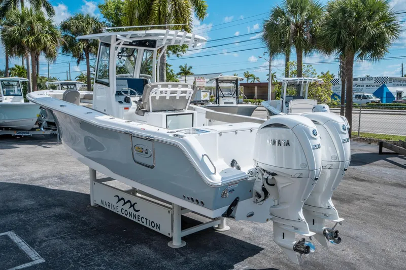 Slide: The Image of 2025 Sea Hunt Gamefish 27 FS boat with twin Yamaha engines, displayed outdoors. - 4