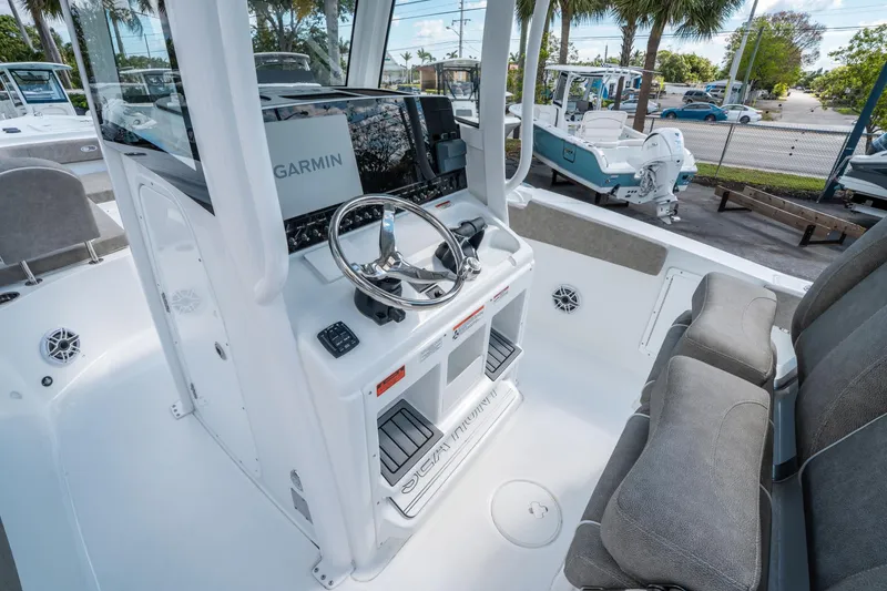Slide: The Image of 2025 Sea Hunt Gamefish 27 FS boat interior with Garmin navigation system and comfortable seating. - 18