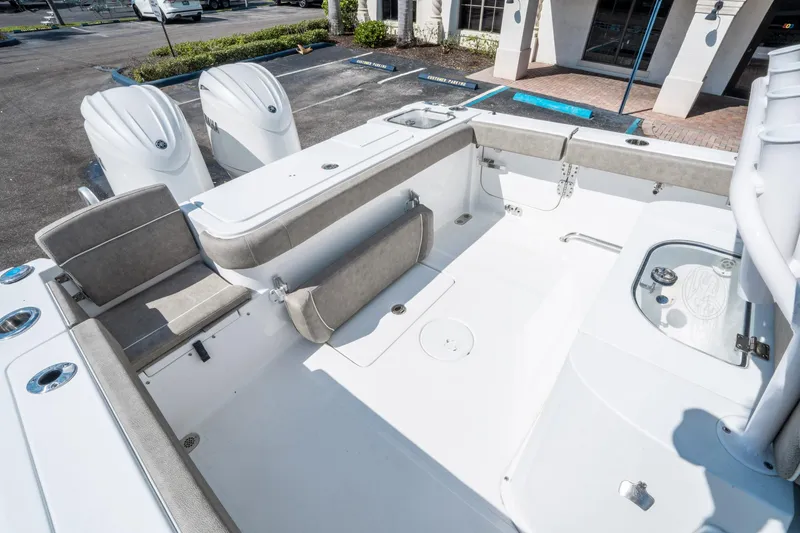 Slide: The Image of 2025 Sea Hunt Gamefish 27 FS boat interior with seating and dual engines. - 12