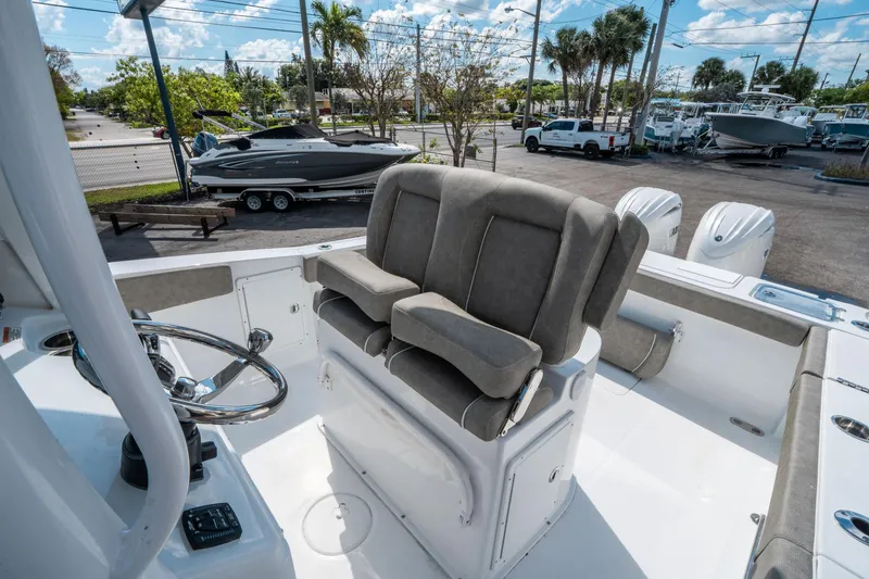 Slide: The Image of 2025 Sea Hunt Gamefish 27 FS boat interior with dual seats and steering wheel. - 20