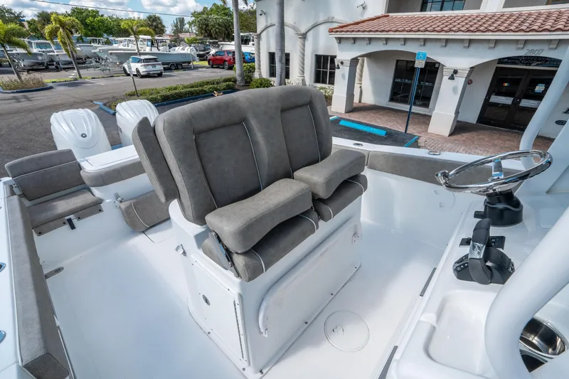 Slide: The Image of 2025 Sea Hunt Gamefish 27 FS boat interior with helm and seating area. - 21