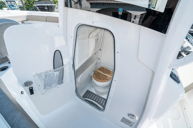 Slide: The Image of 2025 Sea Hunt Gamefish 27 FS boat interior with compact marine toilet. - 28