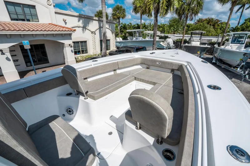 Slide: The Image of 2025 Sea Hunt Gamefish 27 FS boat interior with cushioned seating and cup holders. - 31
