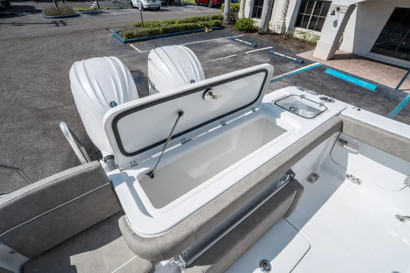 Slide: The Image of 2025 Sea Hunt Gamefish 27 FS boat with open storage compartment and twin engines. - 14