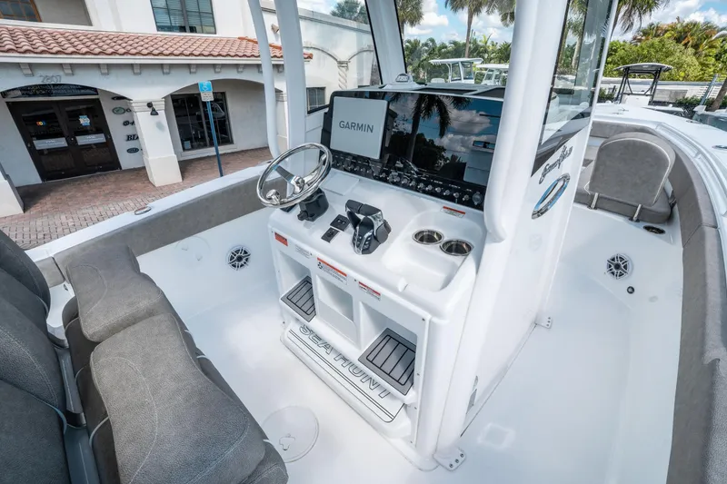 Slide: The Image of 2025 Sea Hunt Gamefish 27 FS boat interior with Garmin navigation system and comfortable seating. - 19