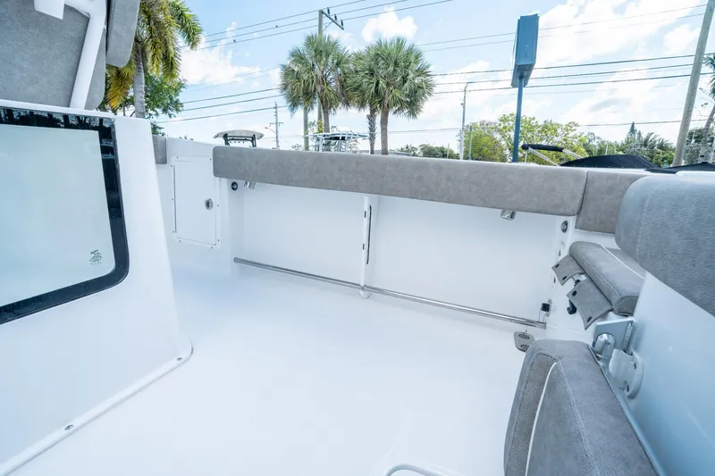 Slide: The Image of 2025 Sea Hunt Gamefish 27 FS boat interior with cushioned seating and storage compartments. - 26