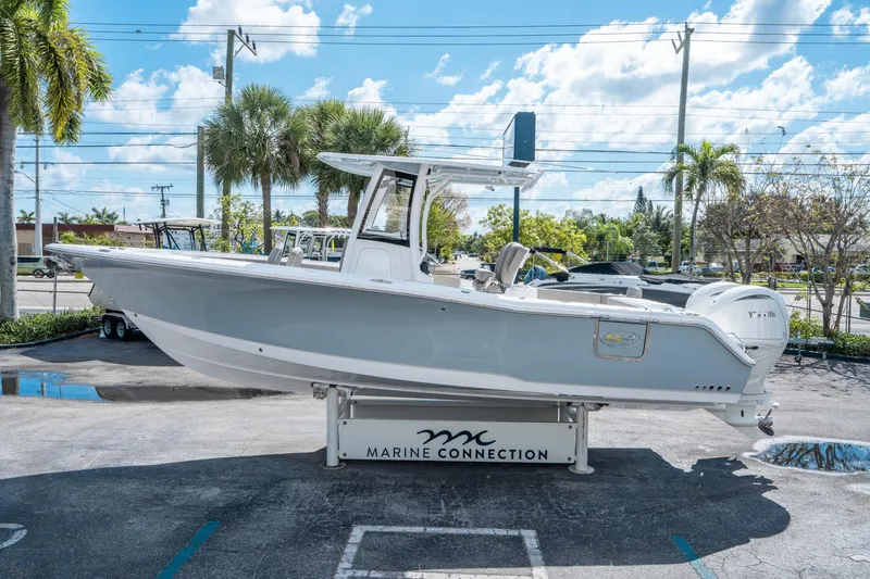 Slide: The Image of 2025 Sea Hunt Gamefish 27 FS boat displayed outdoors on a sunny day. - 5
