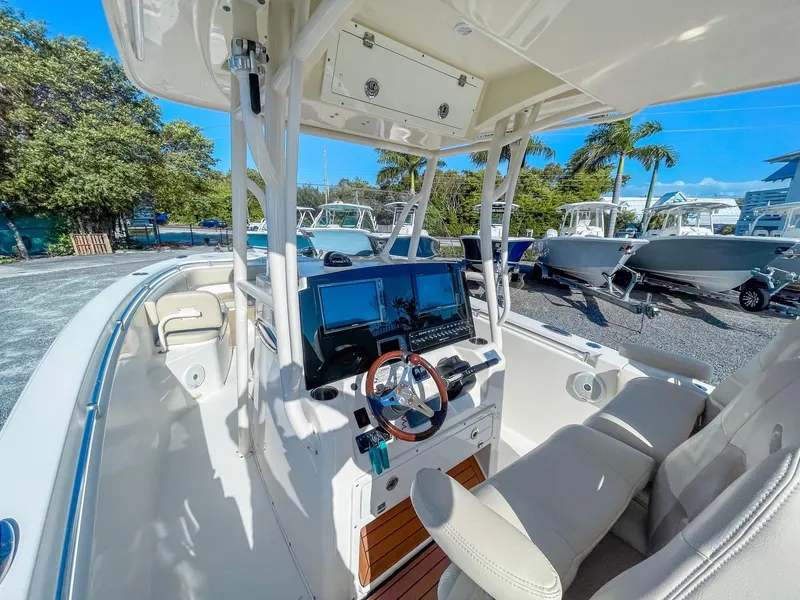 Slide: The Image of 2016 Cobia 277 CC boat interior with modern helm and seating. - 11