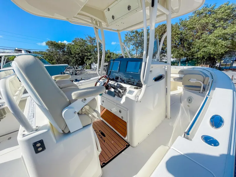 Slide: The Image of 2016 Cobia 277 CC boat interior with helm, seats, and navigation equipment. - 12