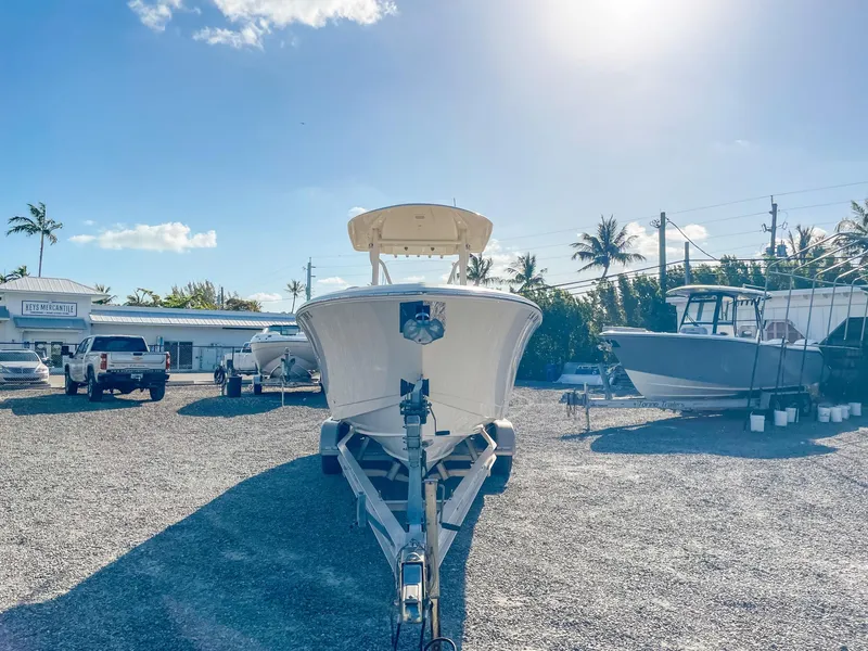 Slide: The Image of 2016 Cobia 277 CC boat on trailer in sunny outdoor lot. - 7