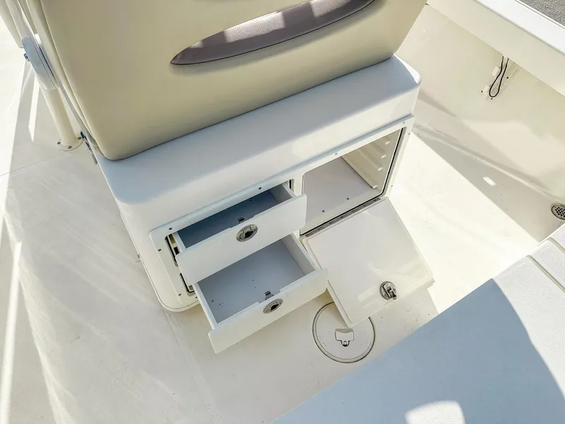 Slide: The Image of 2017 Pathfinder 2600 TRS boat storage compartments with open drawers and hatch. - 10