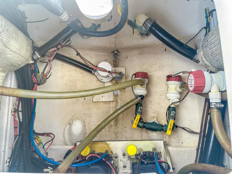 Slide: The Image of Engine compartment of a 2017 Pathfinder 2600 TRS boat, showing hoses and wiring. - 11