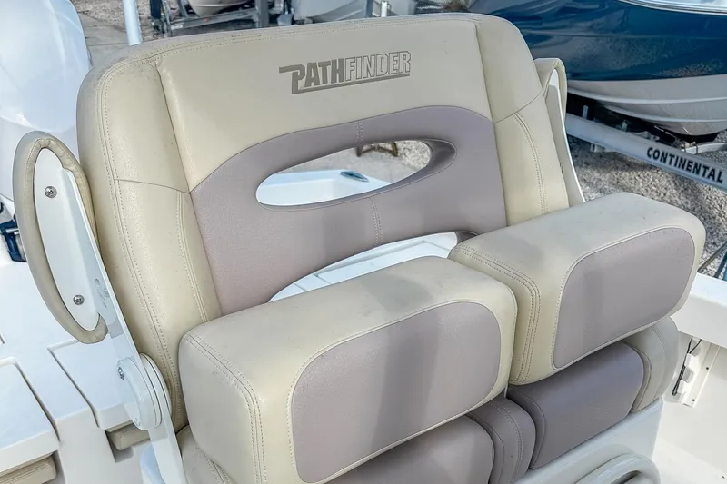 Slide: The Image of 2017 Pathfinder 2600 TRS boat seat with beige and gray cushioned design. - 15