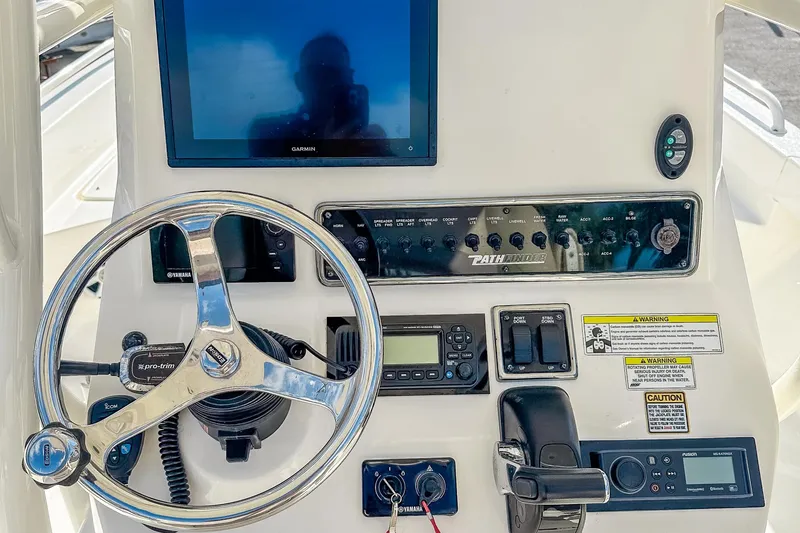 Slide: The Image of 2017 Pathfinder 2600 TRS boat dashboard with steering wheel and navigation controls. - 17