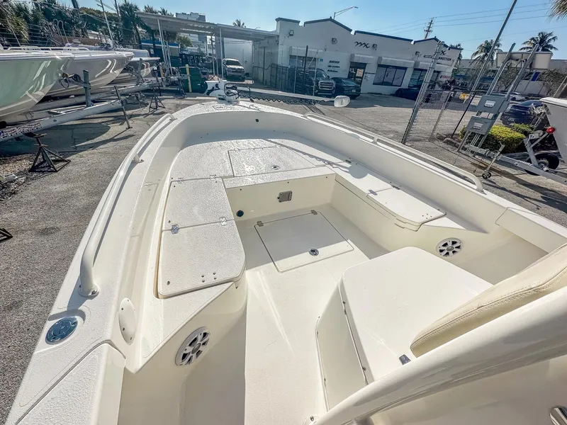 Slide: The Image of 2017 Pathfinder 2600 TRS boat interior, spacious deck, white finish, outdoor setting. - 21