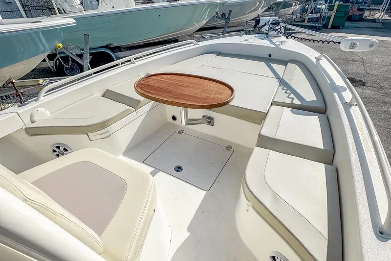 Slide: The Image of 2017 Pathfinder 2600 TRS boat interior with seating and wooden table. - 22