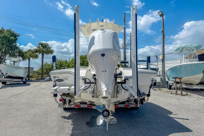 Slide: The Image of 2017 Pathfinder 2600 TRS boat rear view with outboard motor, parked outdoors. - 4