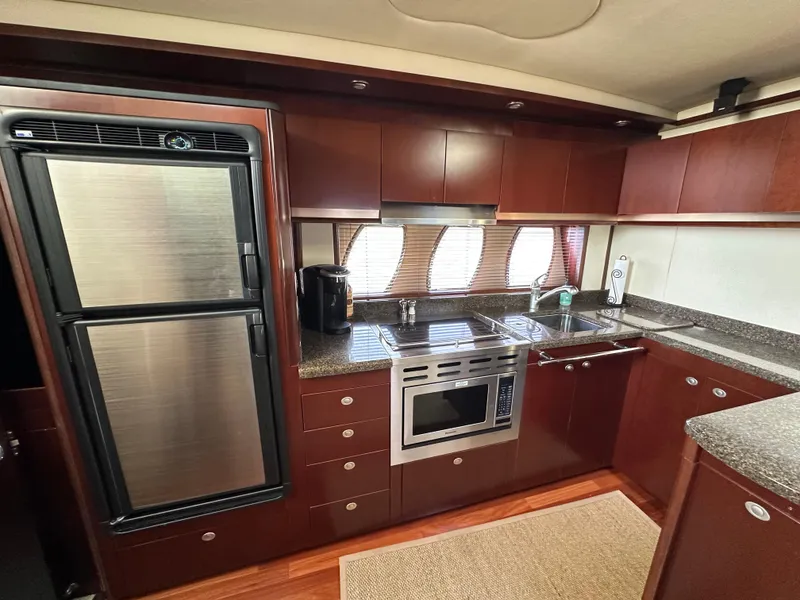 Slide: The Image of Luxurious kitchen interior of 2006 Sea Ray 48 Sundancer yacht with modern appliances. - 23