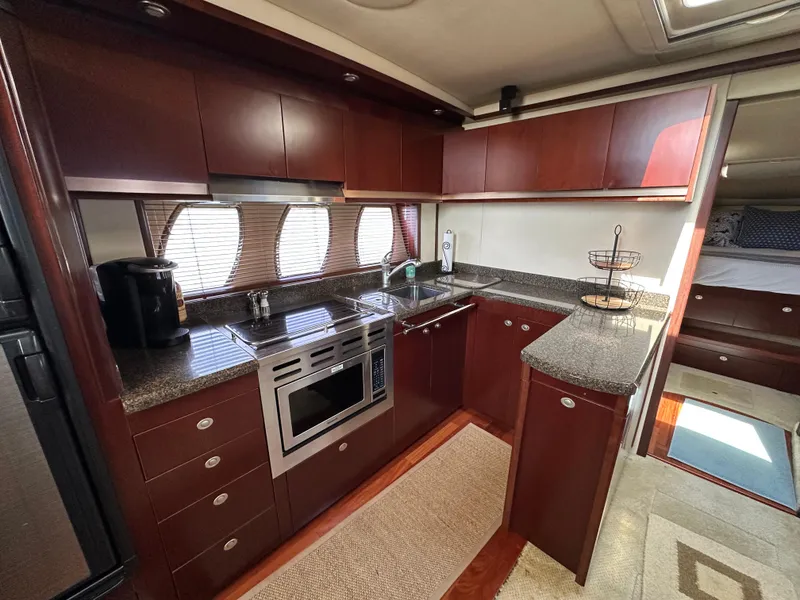 Slide: The Image of Luxurious kitchen interior of 2006 Sea Ray 48 Sundancer yacht with modern appliances. - 24