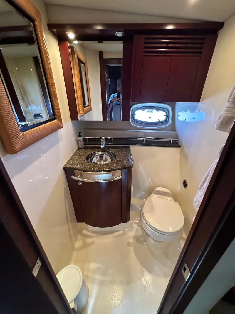 Slide: The Image of Luxurious bathroom in 2006 Sea Ray 48 Sundancer yacht with modern fixtures and porthole. - 26