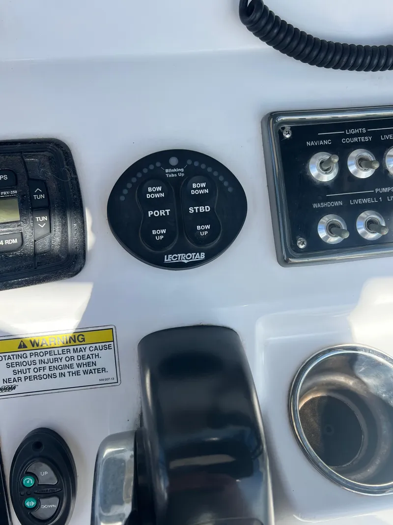 Slide: The Image of Control panel of a 2014 Sportsman Masters 247 Bay Boat with various switches and dials. - 10
