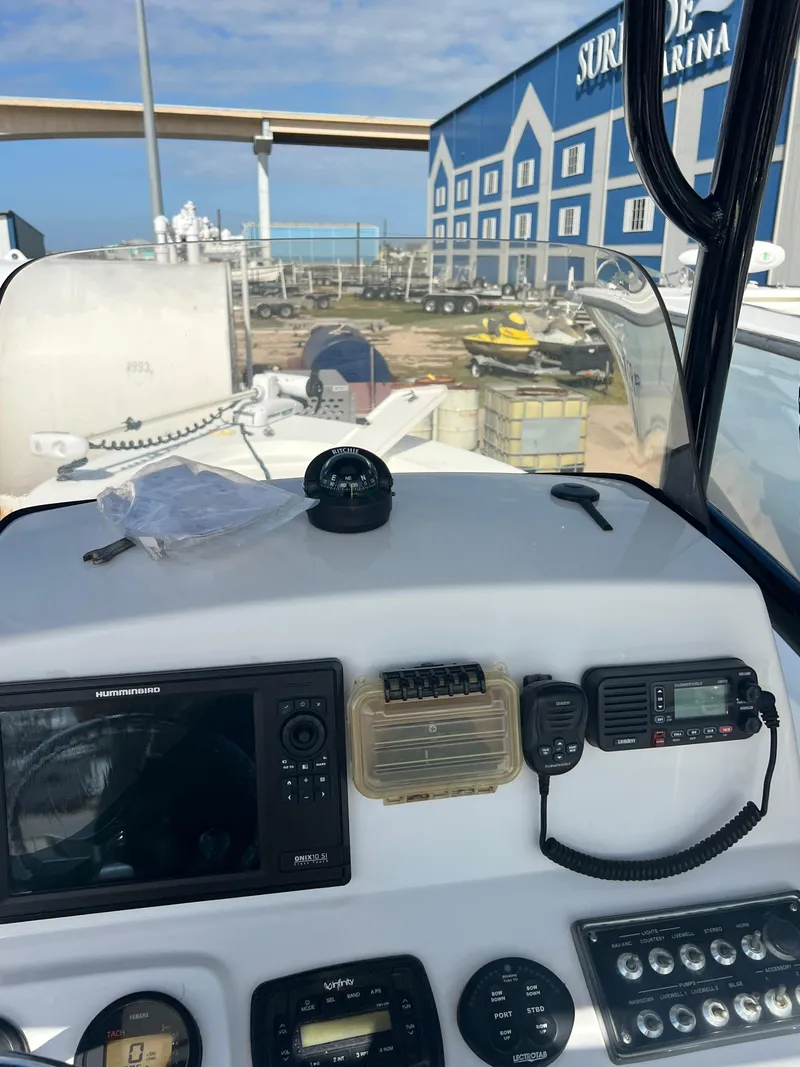 Slide: The Image of Control panel of a 2014 Sportsman Masters 247 Bay Boat at a marina. - 11