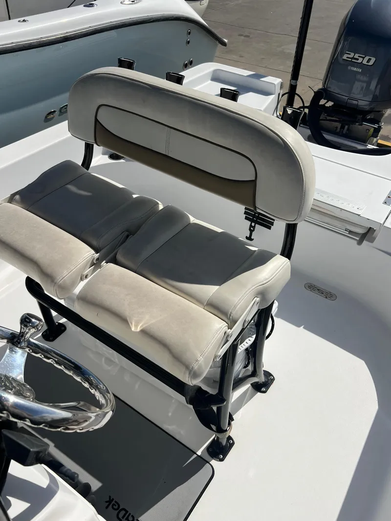 Slide: The Image of 2014 Sportsman Masters 247 Bay Boat interior with seating and steering wheel. - 13