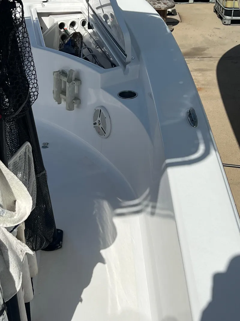 Slide: The Image of 2014 Sportsman Masters 247 Bay Boat deck with fishing gear and storage compartments. - 14