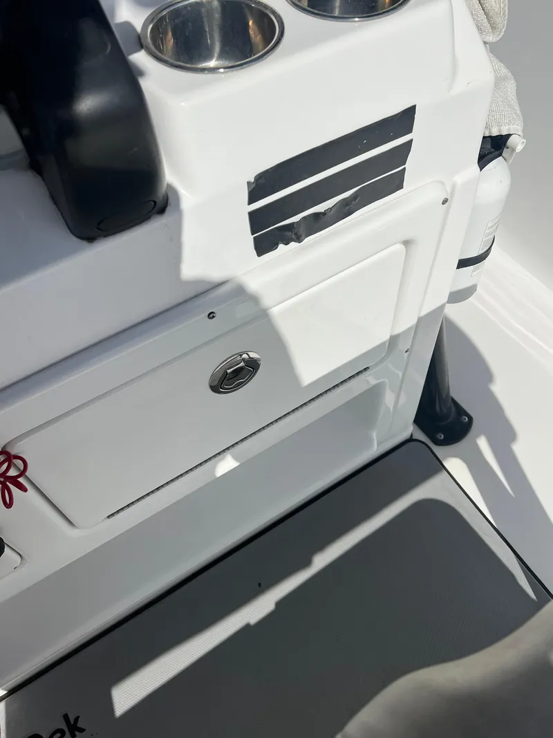 Slide: The Image of 2014 Sportsman Masters 247 Bay Boat interior with storage compartment and cup holders. - 24