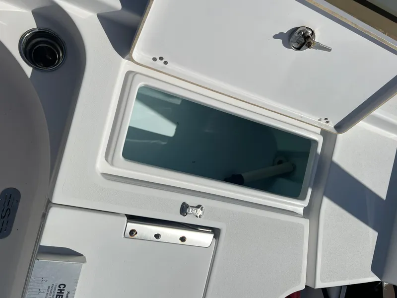 Slide: The Image of 2014 Sportsman Masters 247 Bay Boat storage compartment with lock and handle. - 25