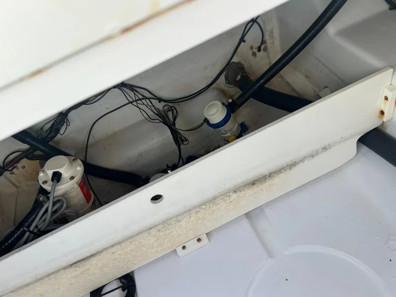 Slide: The Image of 2014 Sportsman Masters 247 Bay Boat wiring and pump system in storage compartment. - 28