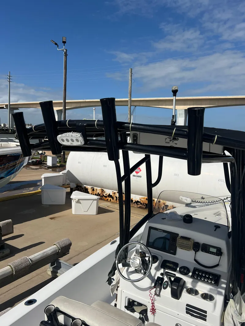 Slide: The Image of 2014 Sportsman Masters 247 Bay Boat with fishing rod holders and control panel. - 29