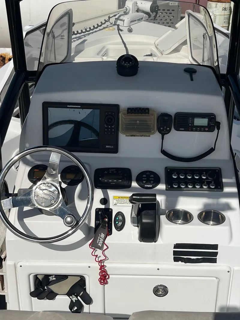 Slide: The Image of 2014 Sportsman Masters 247 Bay Boat dashboard with steering wheel and navigation controls. - 7