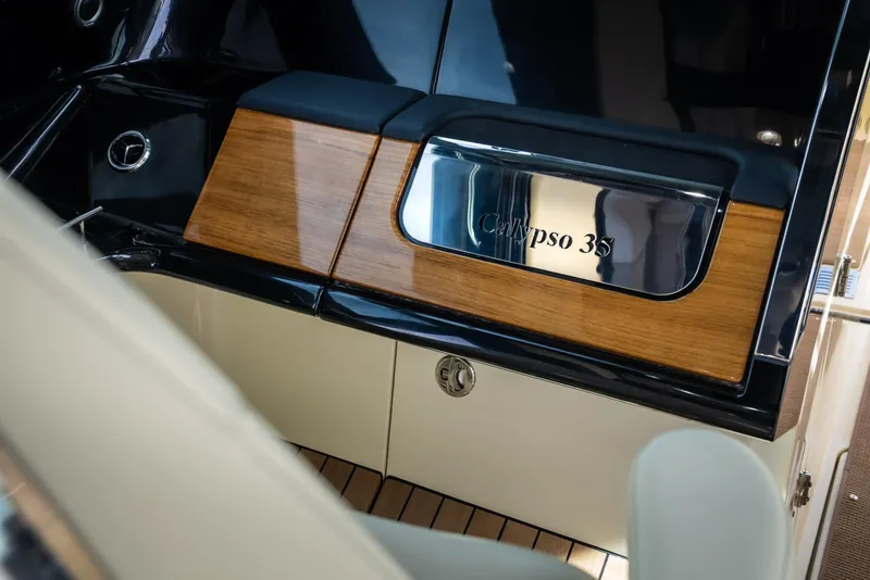 Slide: The Image of 2024 Chris-Craft Calypso 35 CP interior with wood and chrome accents. - 15
