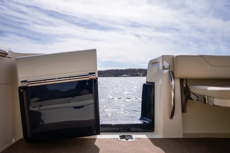 Slide: The Image of 2024 Chris-Craft Calypso 35 CP boat interior with open door, overlooking water. - 17