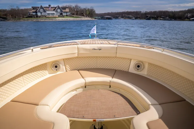 Slide: The Image of 2024 Chris-Craft Calypso 35 CP boat with luxurious seating on a scenic lake. - 19