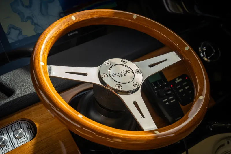Slide: The Image of 2024 Chris-Craft Calypso 35 CP steering wheel, featuring elegant wood and metal design. - 22